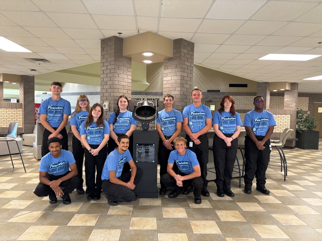 Group of students around the success bell.