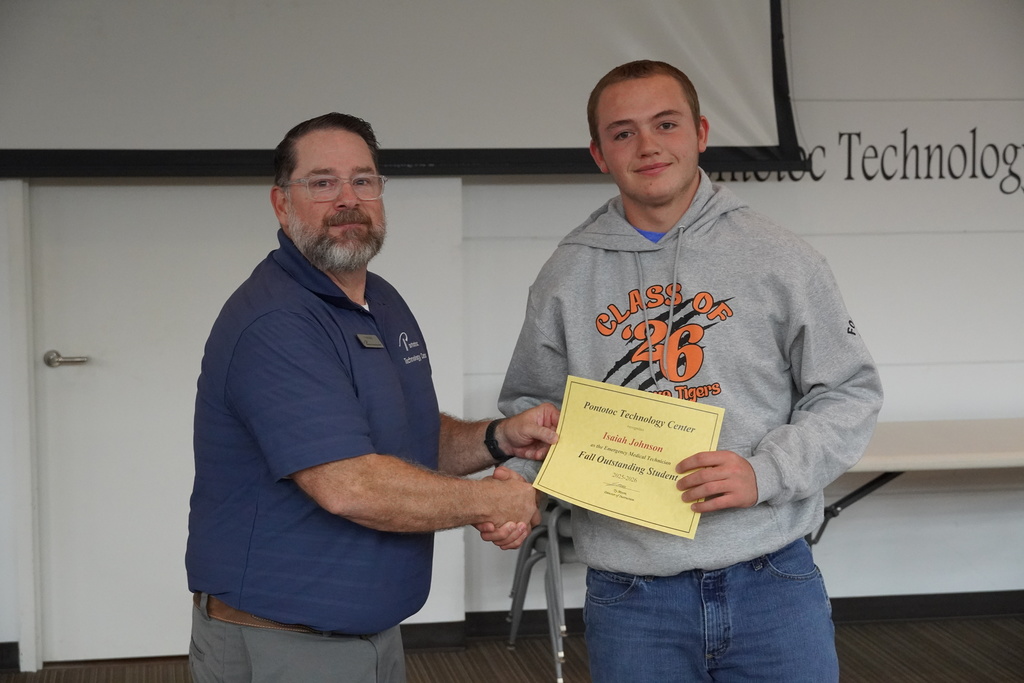 A student and Mr. Moore posing for a photo holding a certificate.
