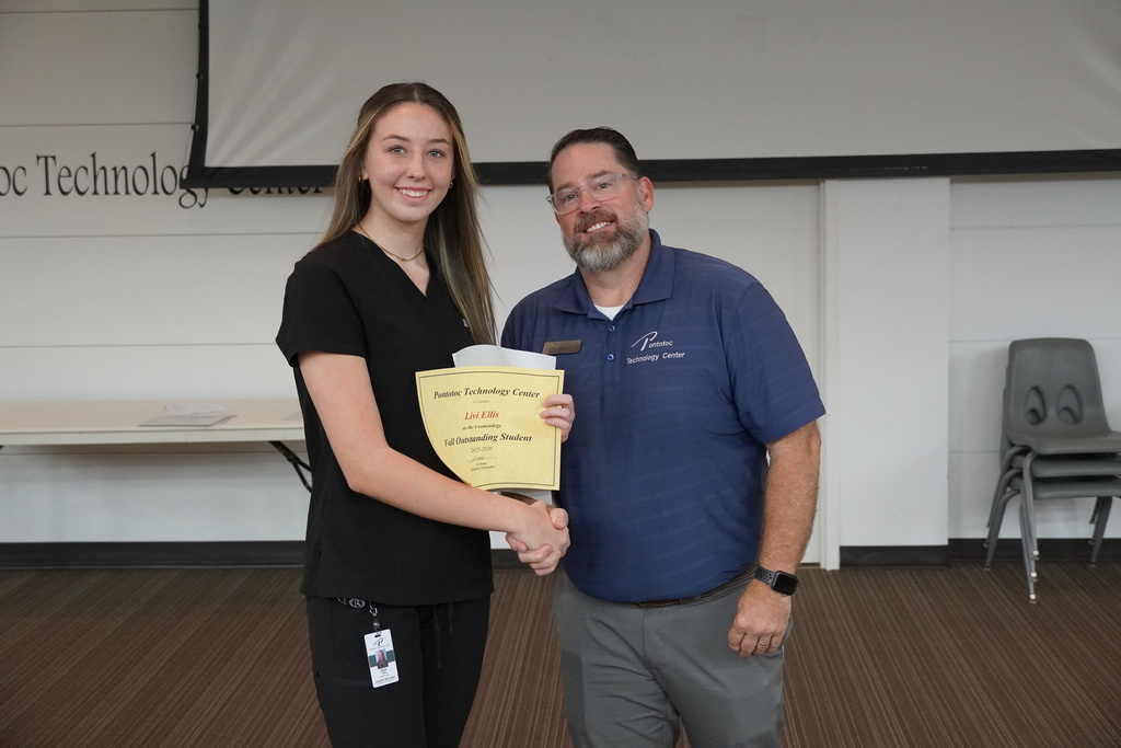 A student and Mr. Moore posing for a photo holding a certificate.