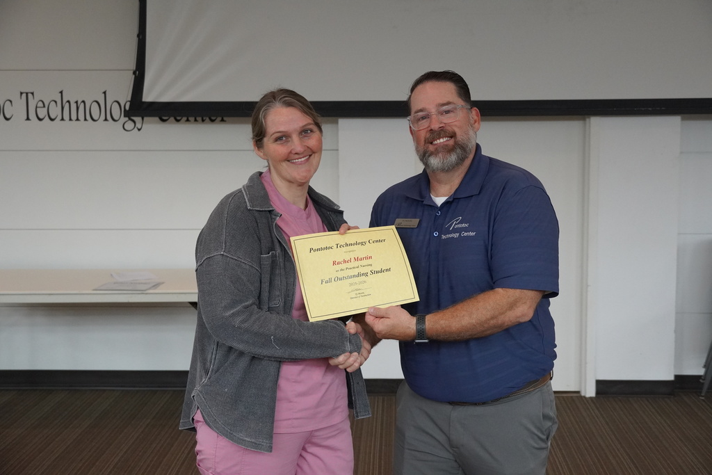 A student and Mr. Moore posing for a photo holding a certificate.