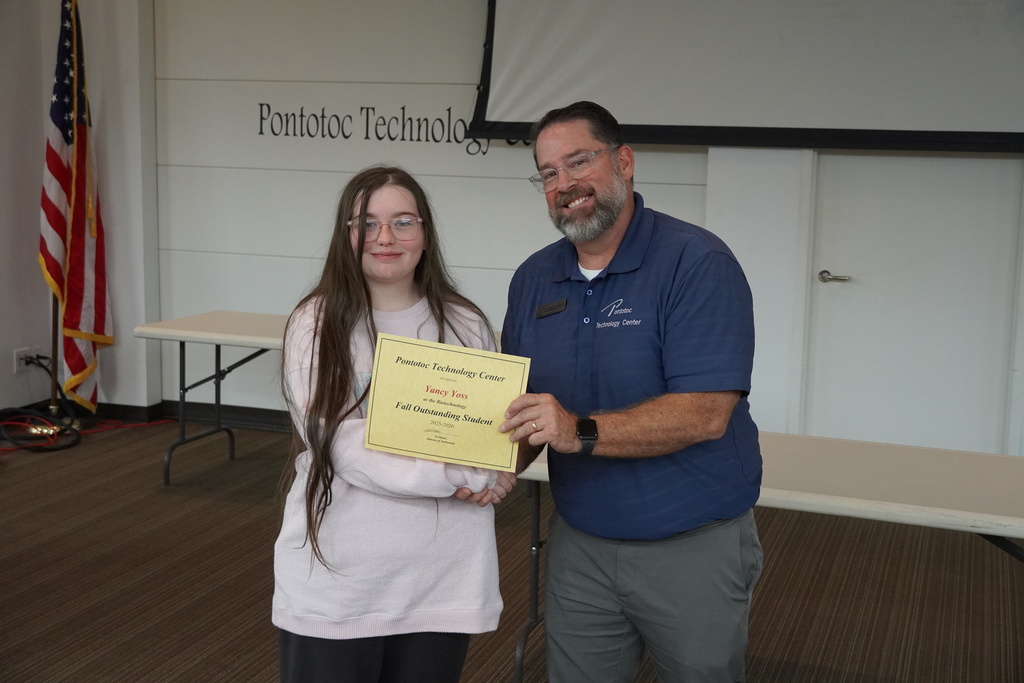 A student and Mr. Moore posing for a photo holding a certificate.