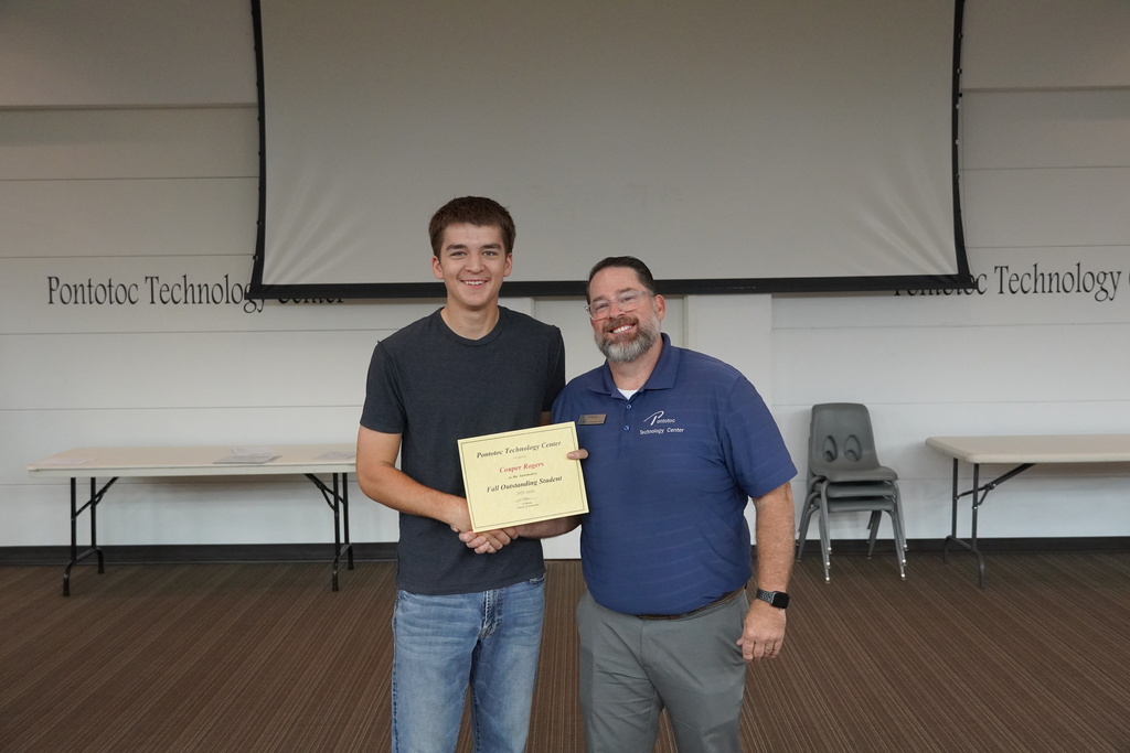 A student and Mr. Moore posing for a photo holding a certificate.