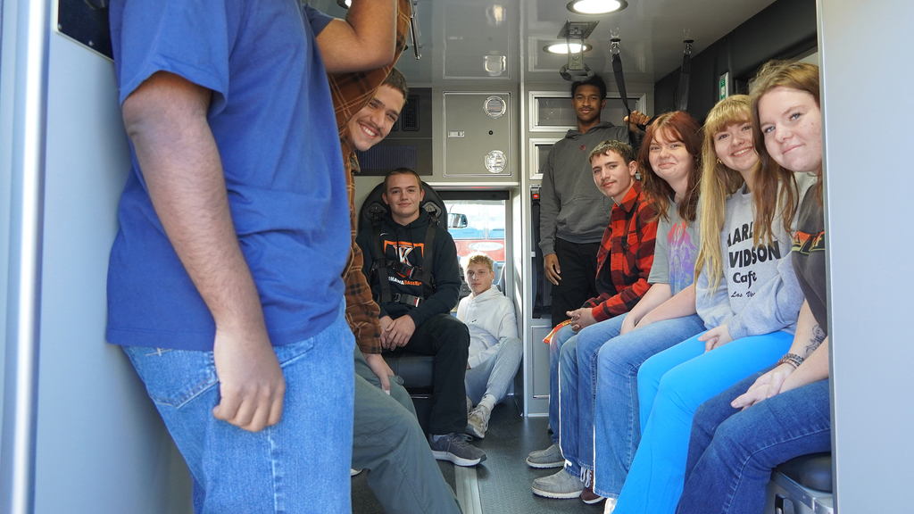 Students sitting in the back of the ambulance