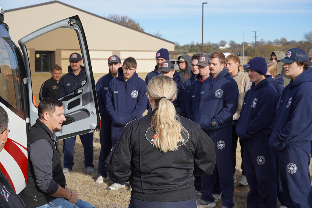 Emergency helicopter pilot presenting and answer questions to a group of students