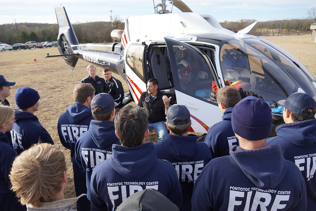 Emergency helicopter pilot presenting and answer questions to a group of students