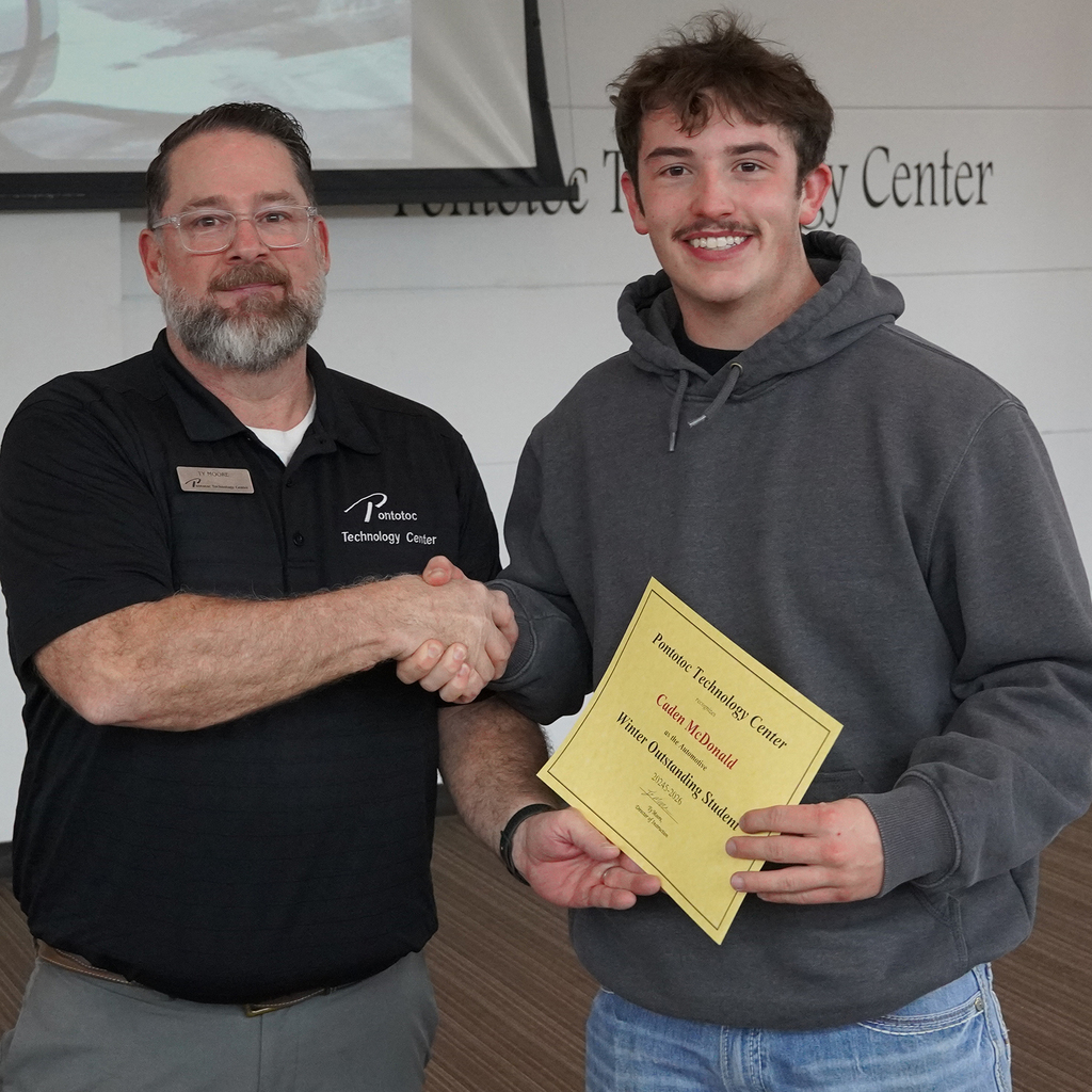 Two people posing with a certificate.