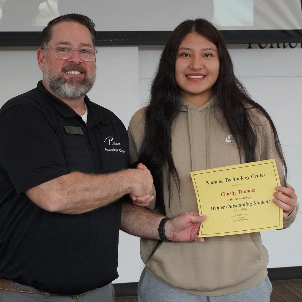Two people posing with a certificate.