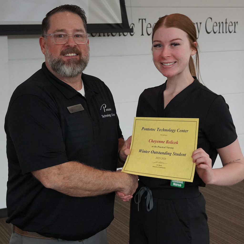 Two people posing with a certificate.