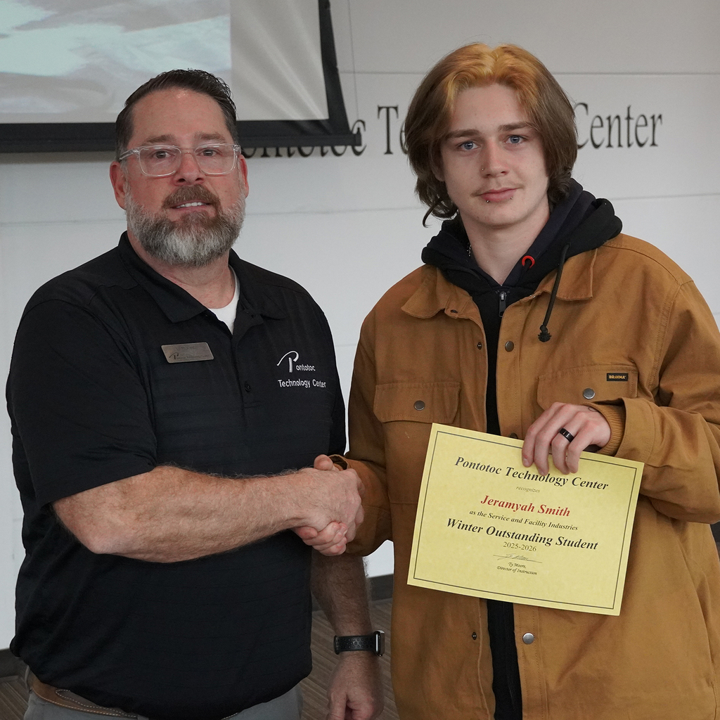 Two people posing with a certificate.