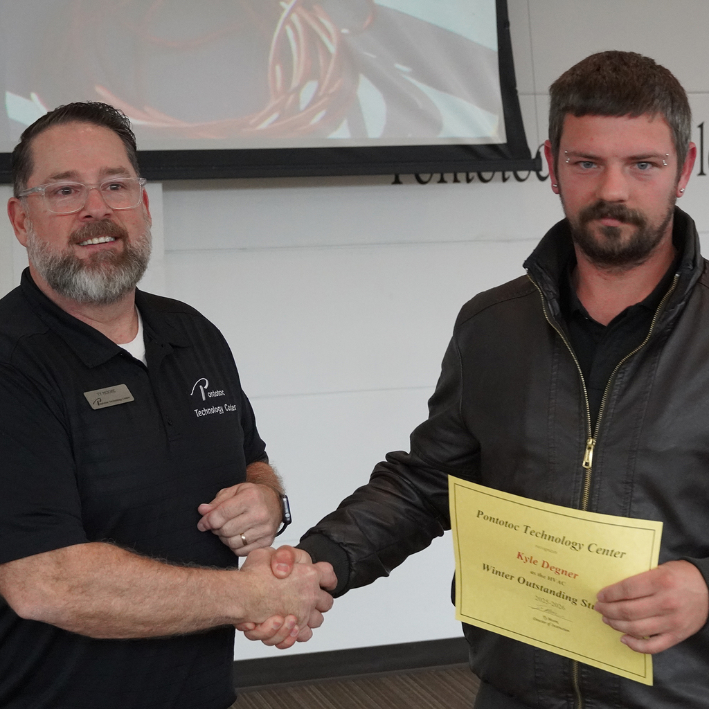Two people posing with a certificate.