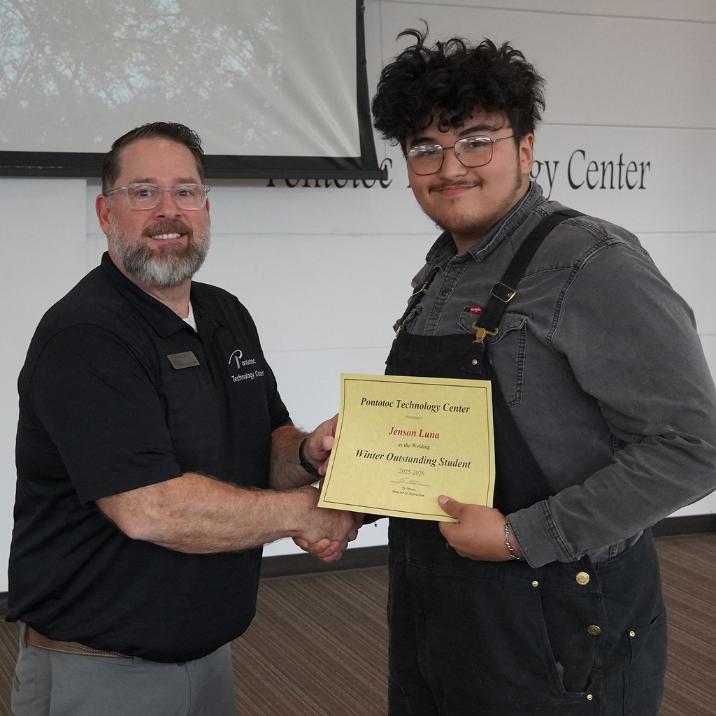Two people posing with a certificate.