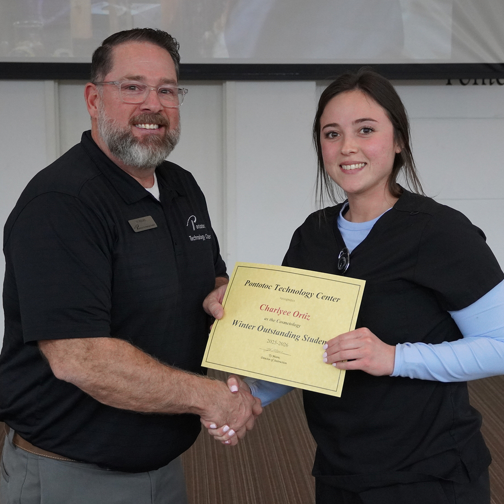 Two people posing with a certificate.