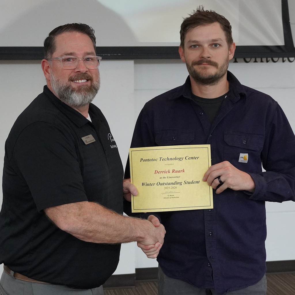 Two people posing with a certificate.
