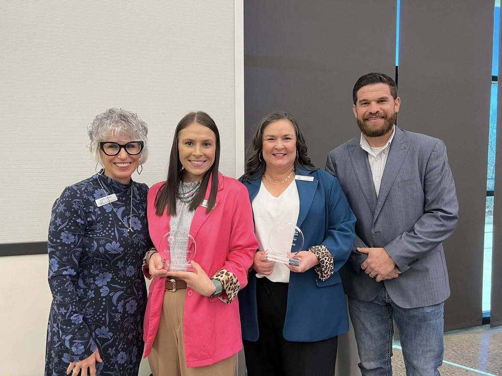Four people posing for a picture.