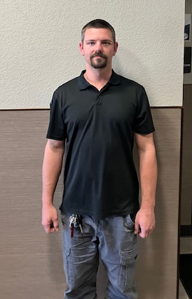 Individual person in a black polo style shirt