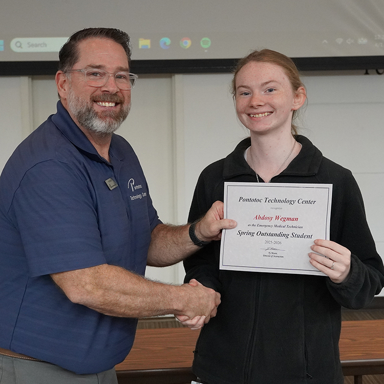 Two people posing with a certificate.