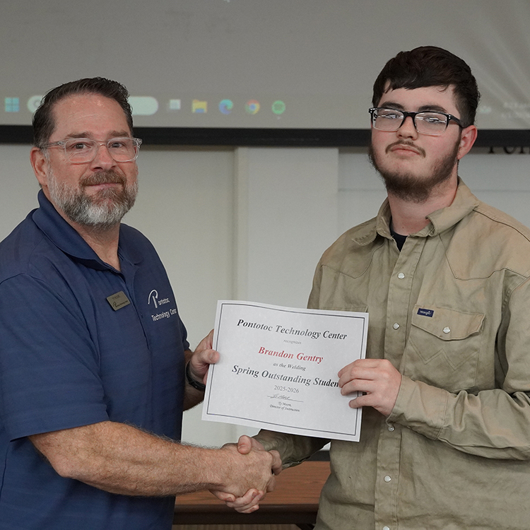Two people posing with a certificate.