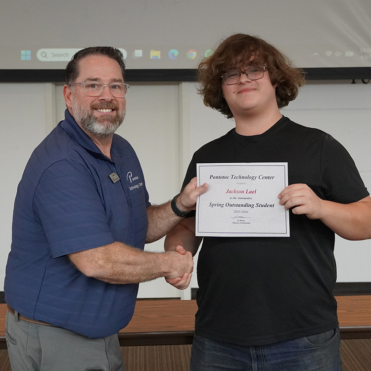 Two people posing with a certificate.