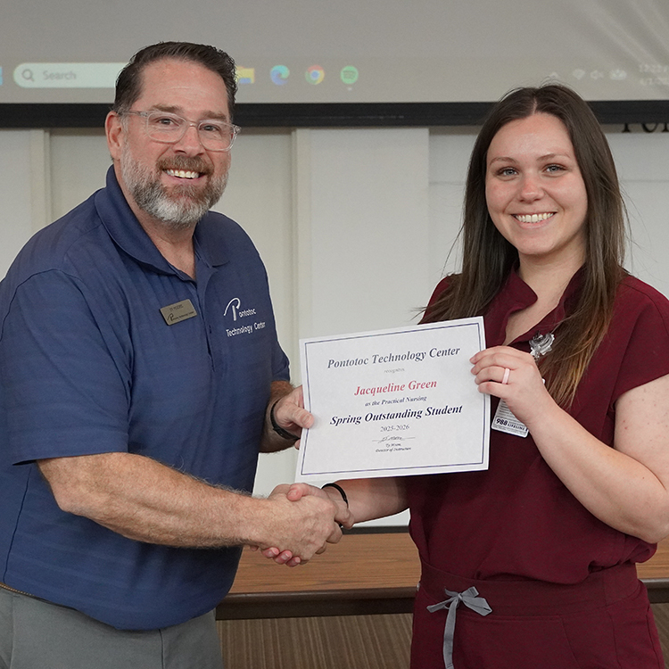 Two people posing with a certificate.