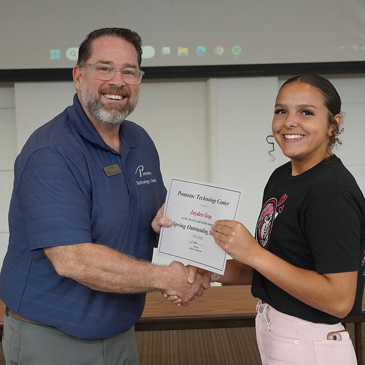 Two people posing with a certificate.