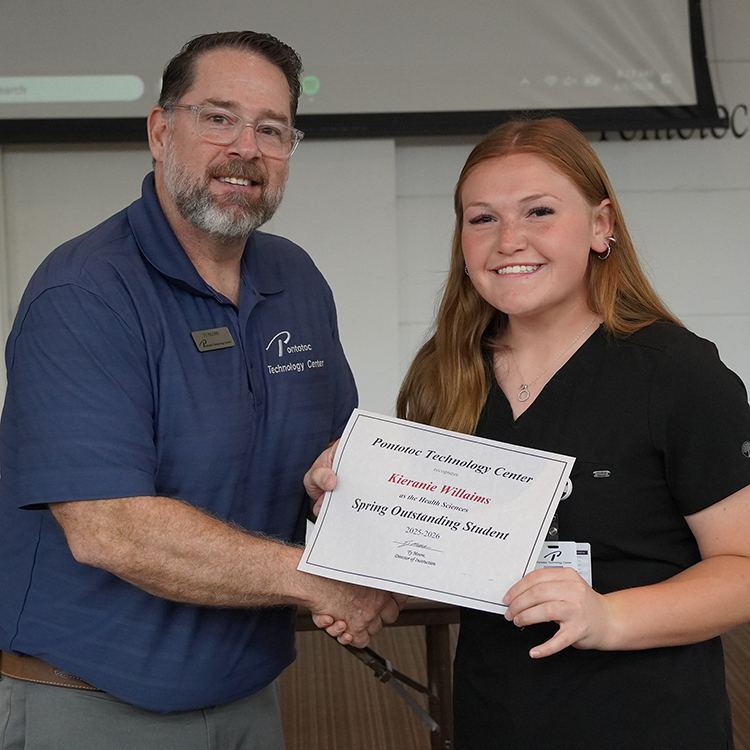 Two people posing with a certificate.
