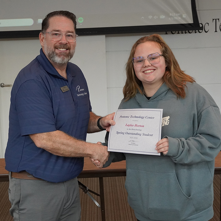 Two people posing with a certificate.