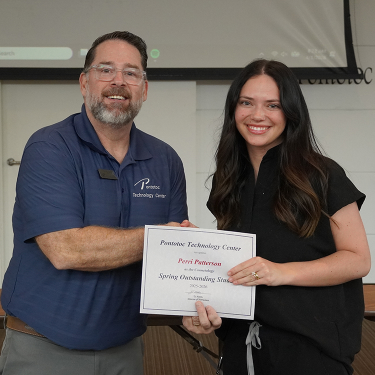 Two people posing with a certificate.