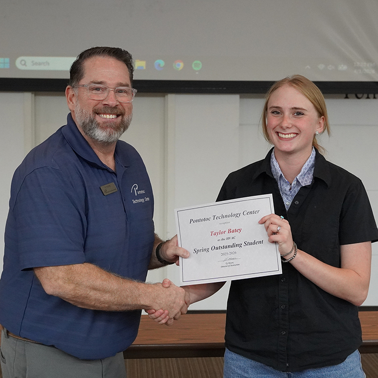 Two people posing with a certificate.
