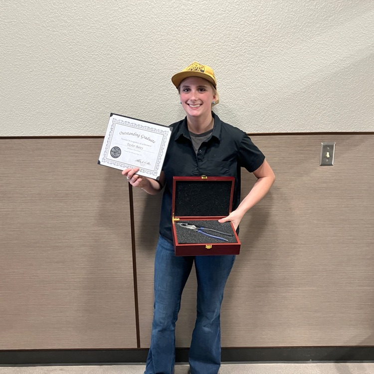 female student holding a certificate and award