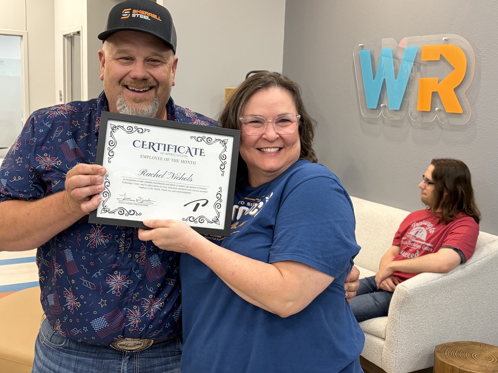 Two people holding a certificate
