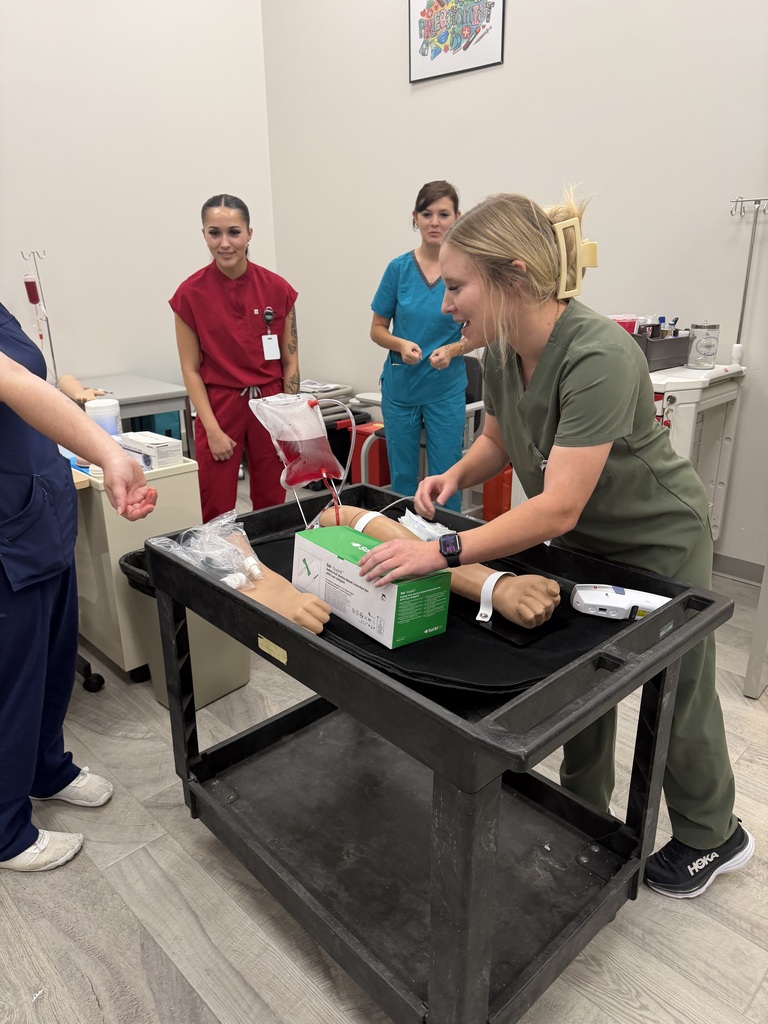 A student practicing skills while three others watch