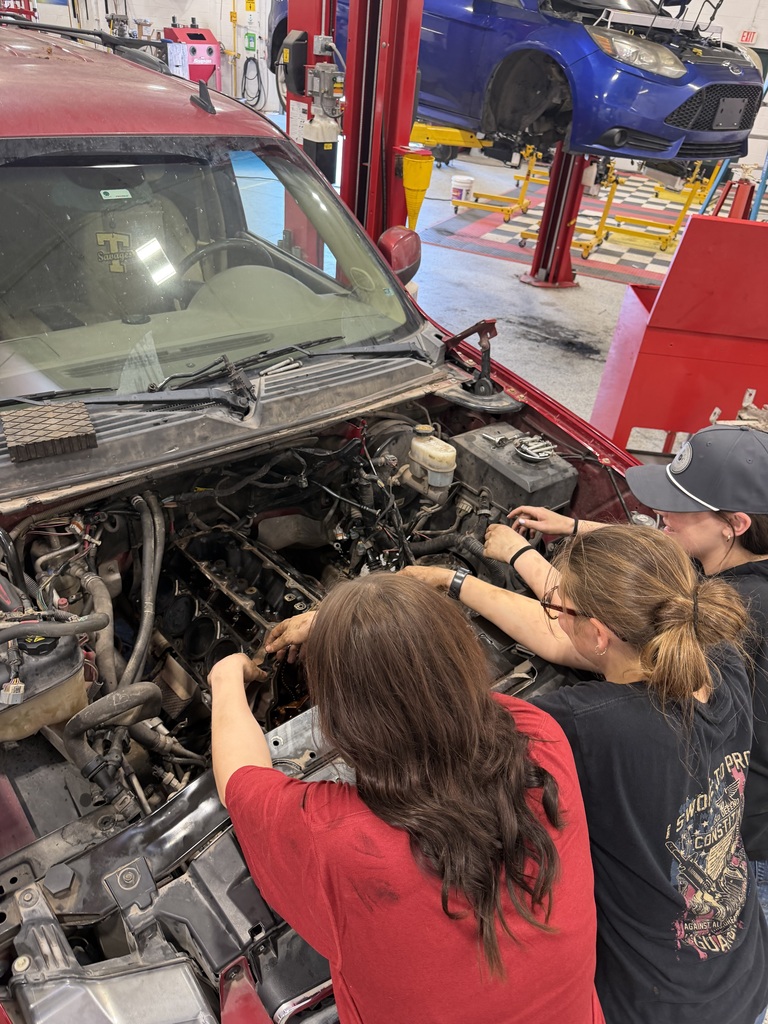 Students working on a vehicle engine