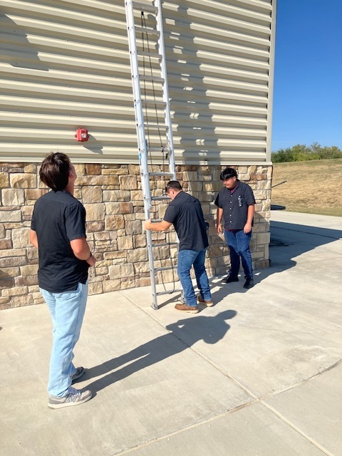 Students working with a ladder