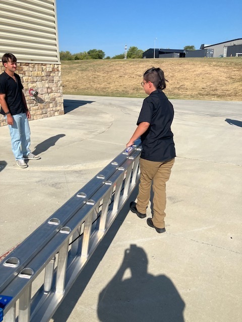 Students working with a ladder