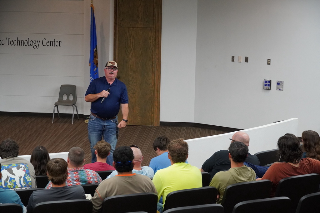 Man presenting to a group of students.