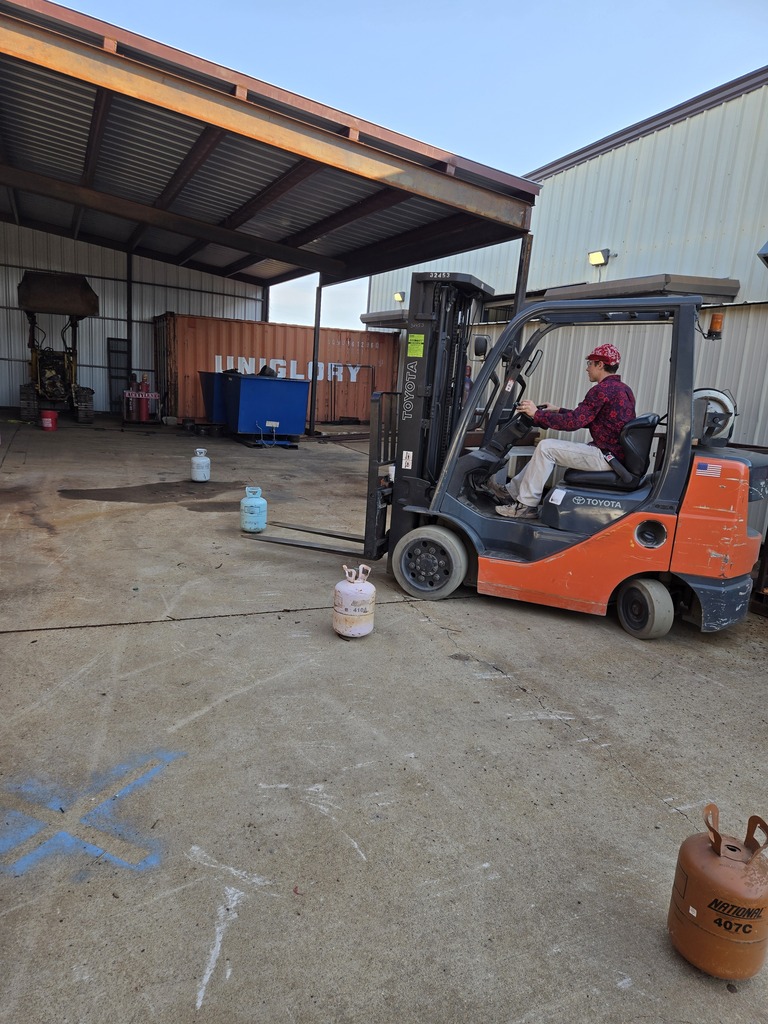 A student driving a forklift