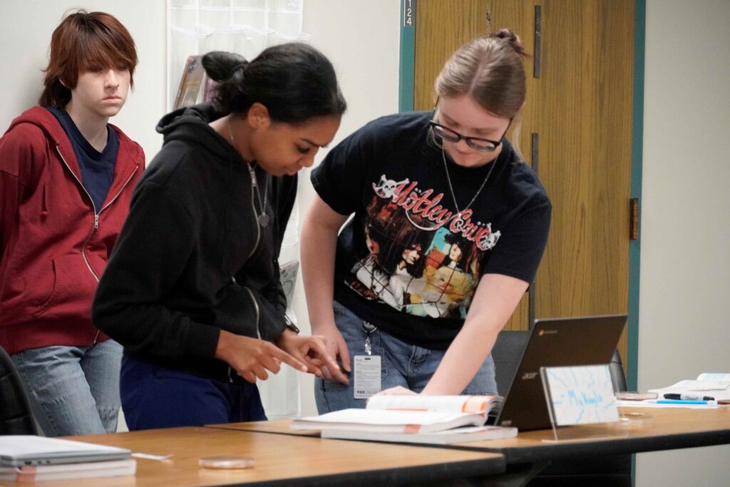 Two people applying samples to a science experiment