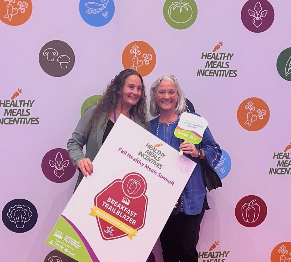two people holding award sign