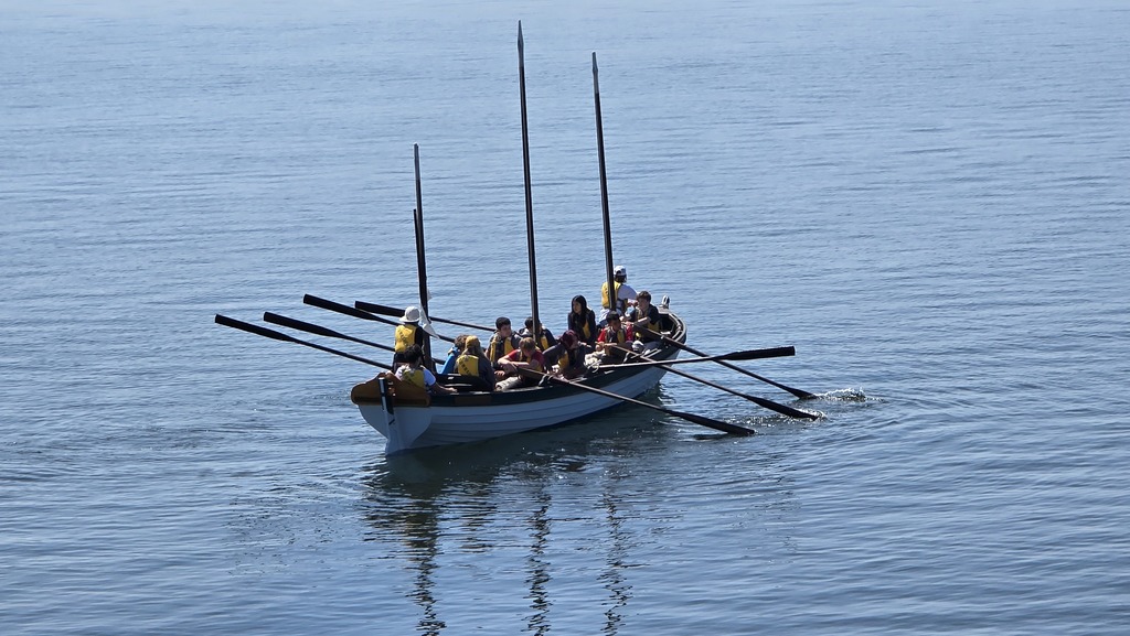 Students in a long boat from Blue Heron