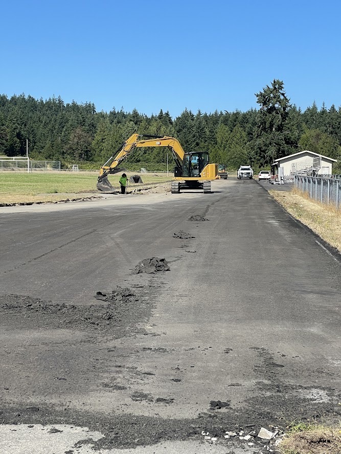 Heavy machinery removes surface of track