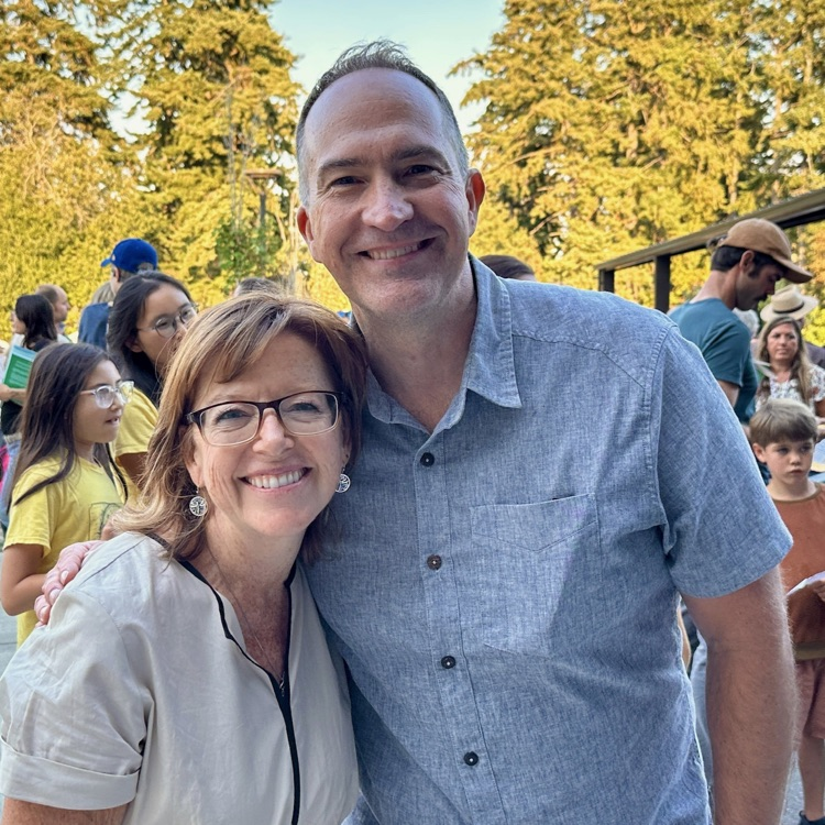 Assistant principal Mr. Lynch and Dean of students Ms. Tracy beam bright smiles at families at back to school night.