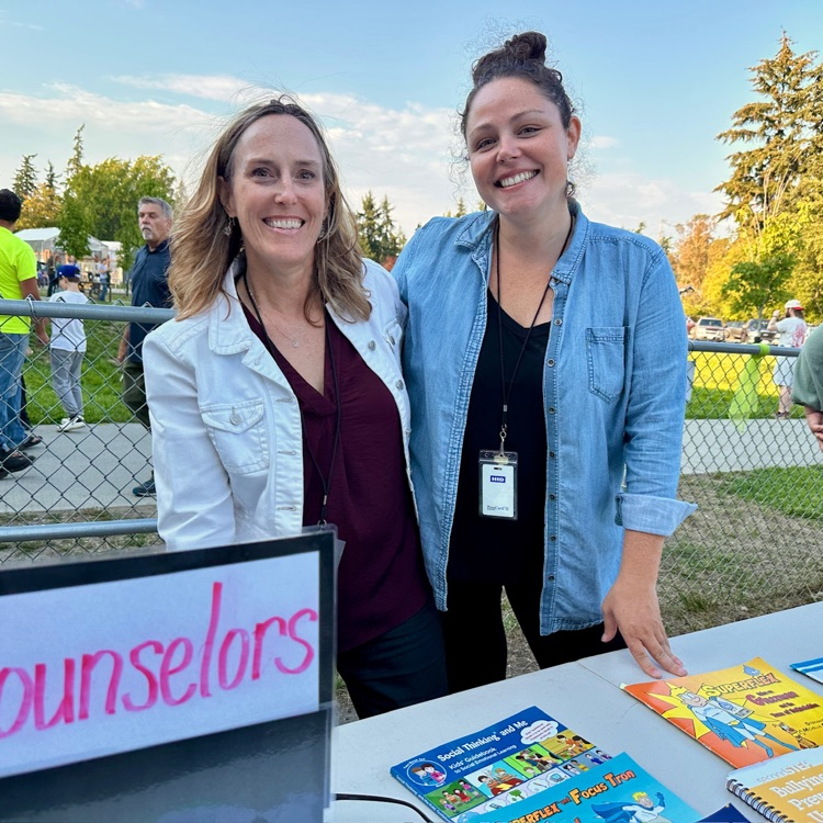 school counselors Ms. Clayton and Ms. Ashley smile for the camera while sharing curriculum at back to school night.