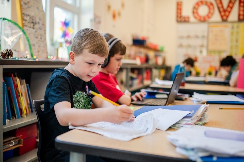 Students writing and using a computer