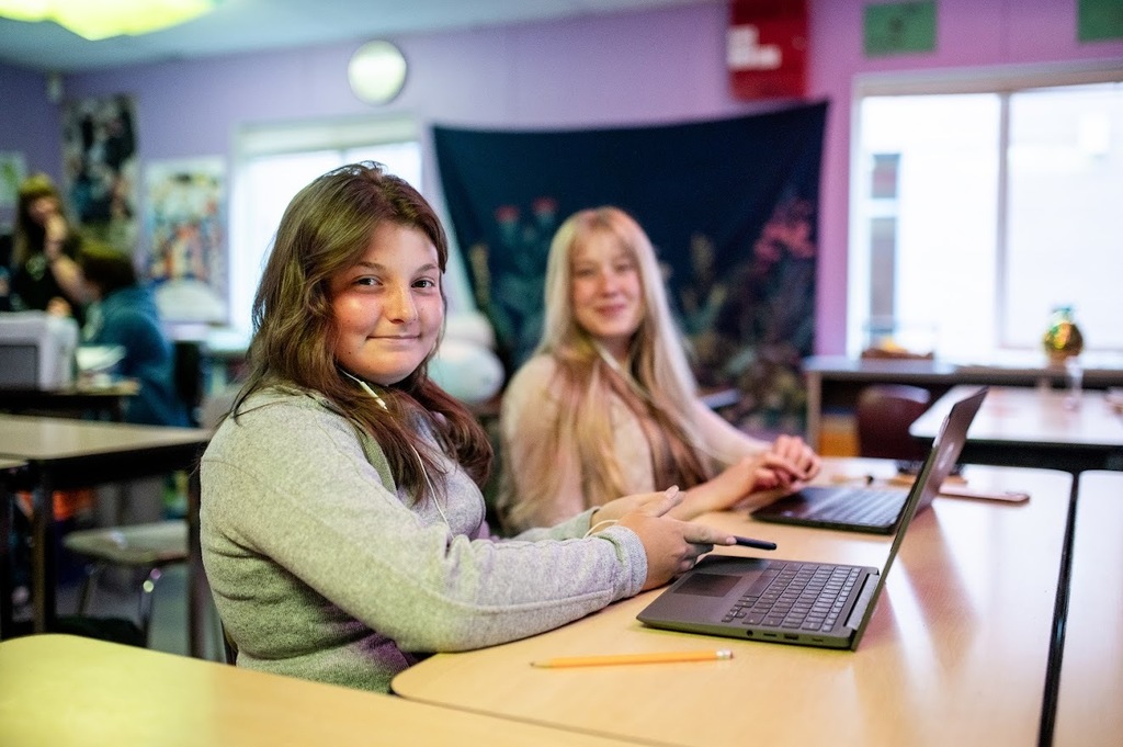 Students work on laptops in OCEAN School