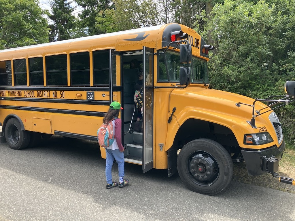 Students board a school bus