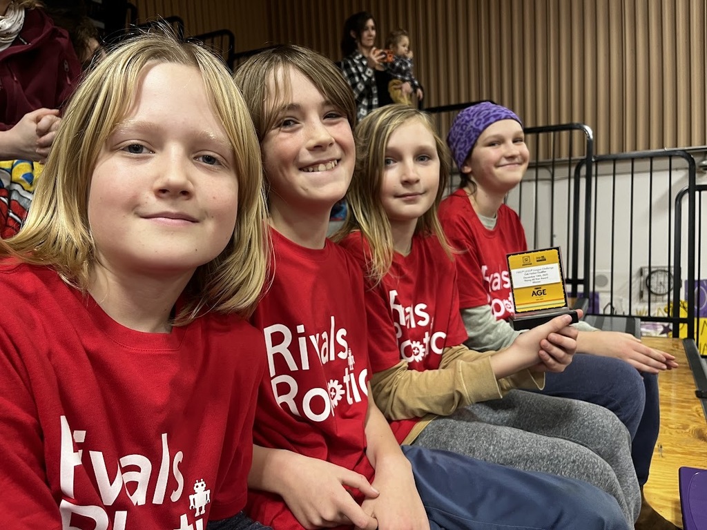 The Otter Bots, wearing their red Rivals Robotics shirts, competed in the First Lego League robotics competition and won the Rising All Stars Award