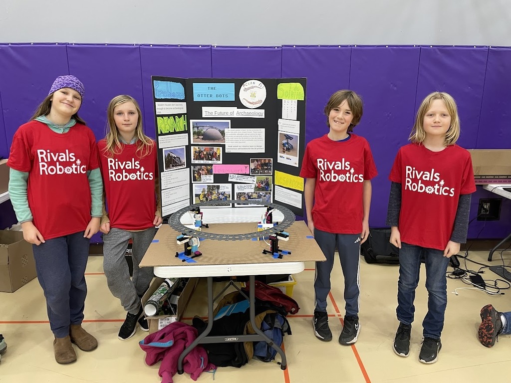 The Otter Bots, wearing their red Rivals Robotics shirts, competed in the First Lego League robotics competition and won the Rising All Stars Award