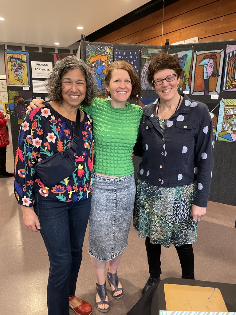 Art teachers pose at student art exhibit