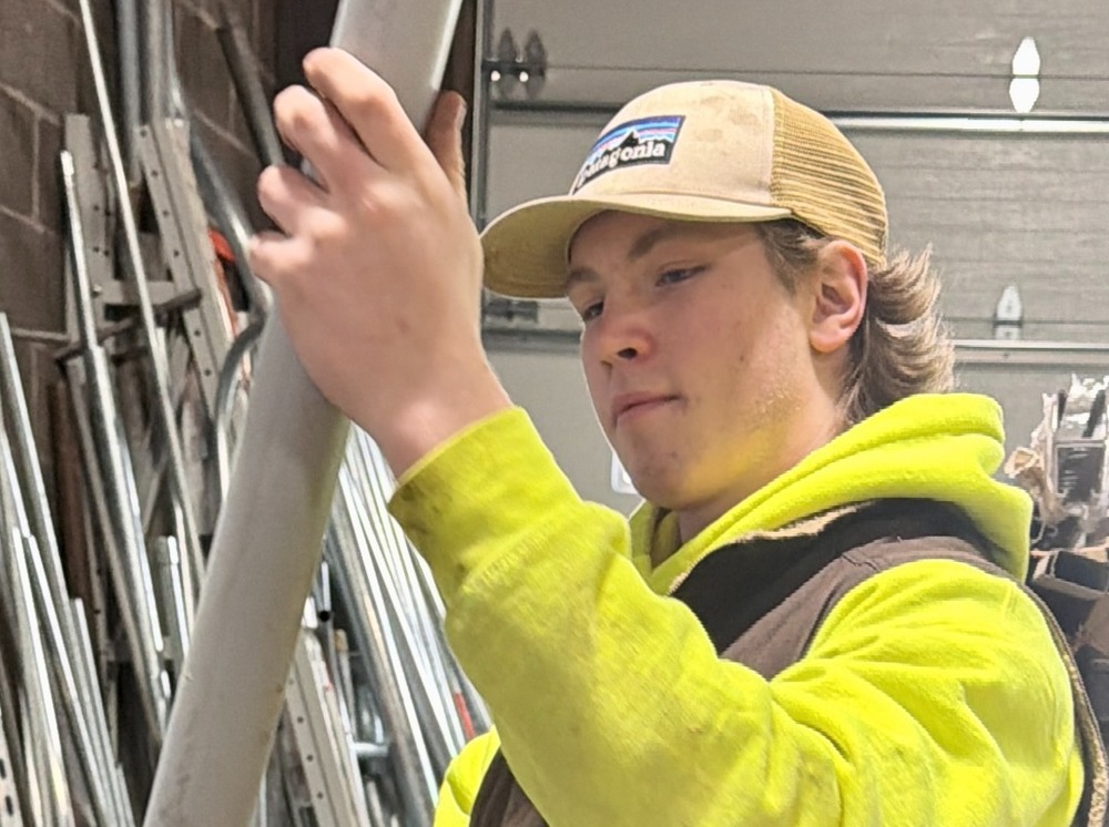 student examining pole