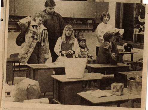 teachers in their new classroom sitting at desks